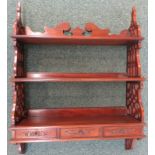 Mahogany reproduction three-shelf wall bracket with three short drawers to the base, pierced