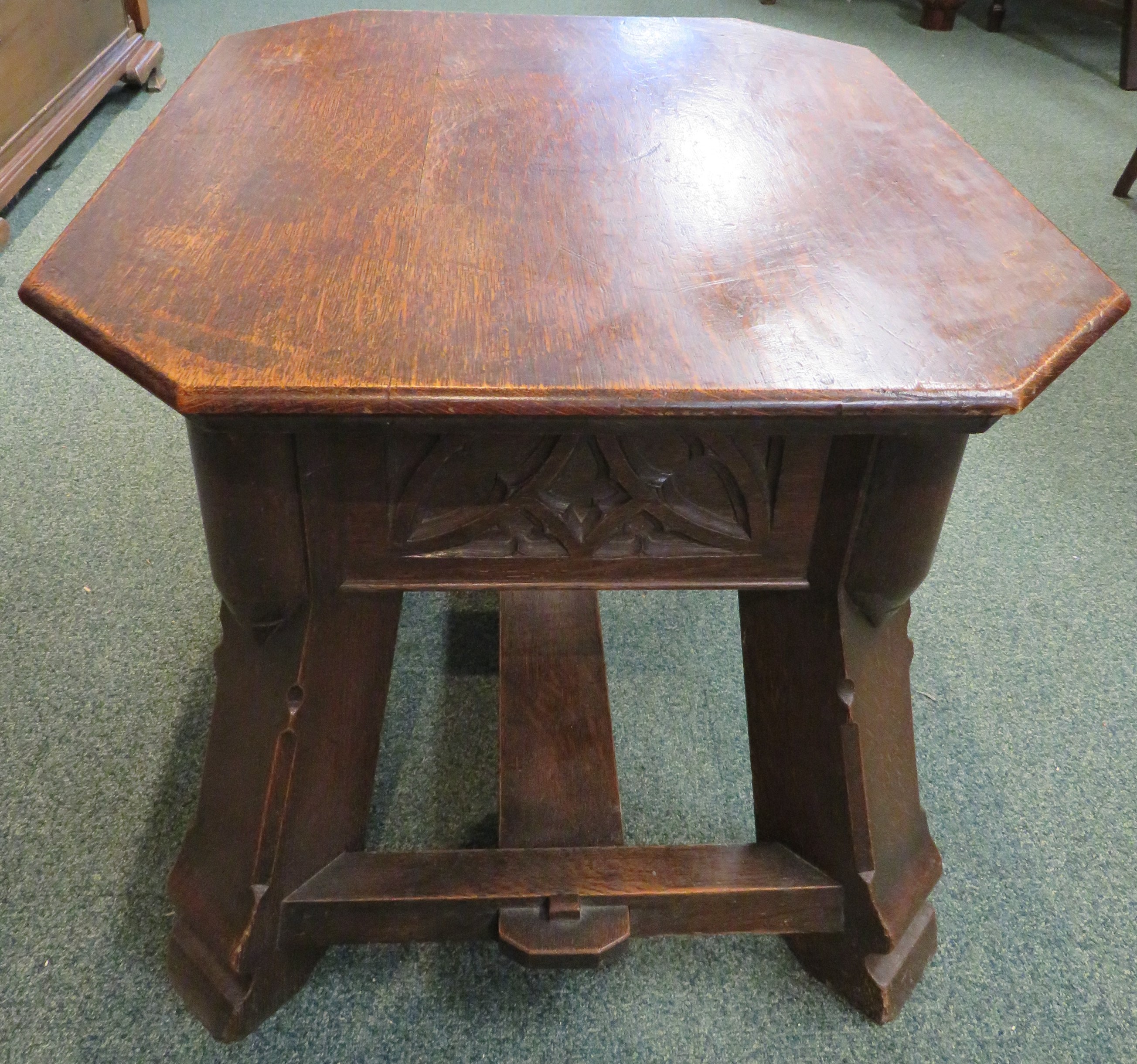 Gothic style oak stool with foliate carving to the frieze and stout stretchered out swept legs, - Image 5 of 5