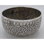 Far Eastern white metal bowl with repousse scrolled foliage between patterned borders, the bottom of