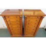 Pair of oak Wellington chests of seven graduated drawers, turned knop handles, acanthus moulding