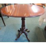 A small oval mahogany lap side table with rotating top, a discrete frieze drawer to each end, on a