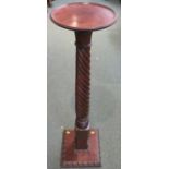 Mahogany plant stand with circular top (diameter 26cm), on a wrythen fluted column on square base,