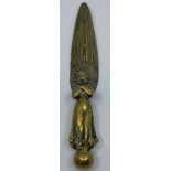 Brass figure of a robed angel with arm folded across chest, upwardly pointed wings and standing on a