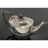 Silver teapot with ebony knop and handle, oval shape half-reeded, marks for Birmingham, 1910,