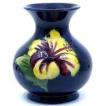 Moorcroft Pottery small baluster vase with flared neck, blue ground with tubelined decoration of red