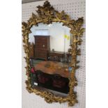 An arch-topped rectangular wall mirror with a gilt wood frame naturistically carved as branches with