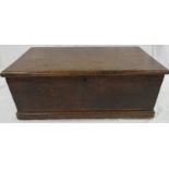 A small early 19th century oak chest with hinged lid and iron carrying handles, the pine bottom,