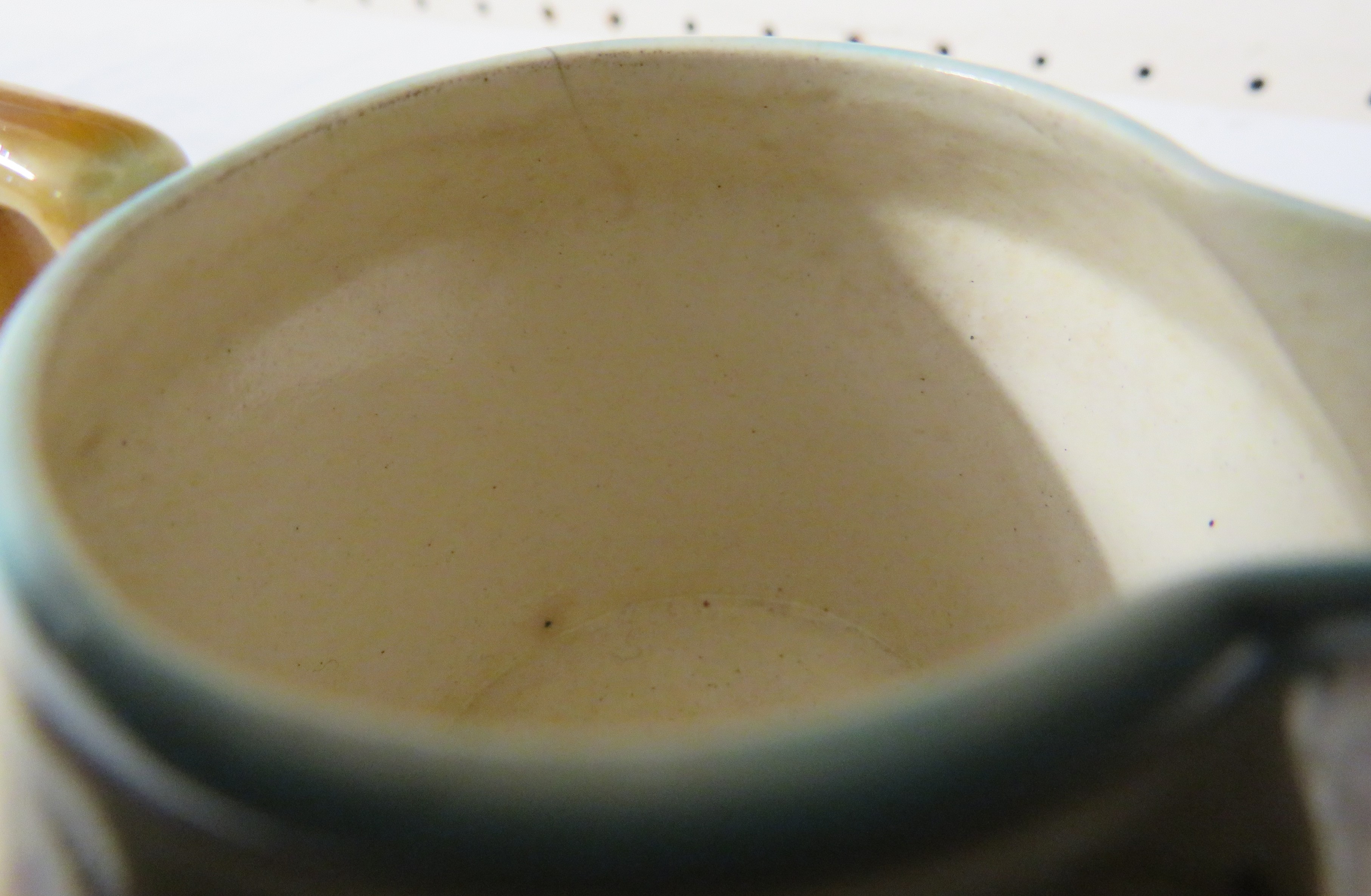 A small Linthorpe Pottery milk jug, pale treacle glaze with blue dots and lines and a band of - Image 5 of 6