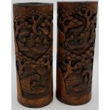 Pair of carved Chinese bamboo brush pots depicting figures in landscapes and boats, height 27cm