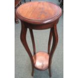 Oak circular top plant stand on four slender sabre legs, with under-tier, early 20th century,