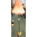 Victorian brass standard lamp with electrical bulb fitting, plain cylindrical column on a circular