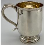 Silver pint tankard with scrolled handle on a stepped circular base, marks for Sheffield, 1960,