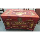 Chinese camphorwood blanket box with hinged lid, gold coloured panels of carved decoration of
