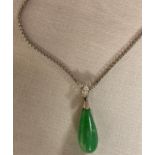 Tear drop pendant of a green jade type stone mounted with a marquise cut diamond (about 4mm x