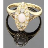 18 carat gold opal and diamond ring, the oval setting with an opal (5.5mm x 4mm) centrally between