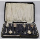 Cased set of six silver Apostle tea spoons and a pair of sugar tongs, marks for Birmingham, 1924,