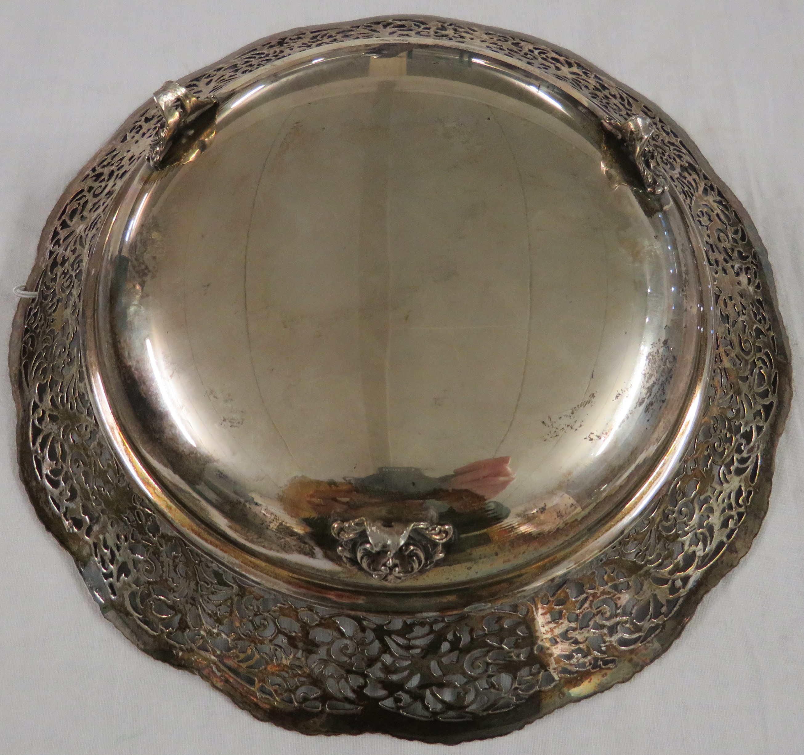 A white metal circular fruit dish with a pierced foliate scrolled border, standing on three - Image 2 of 2