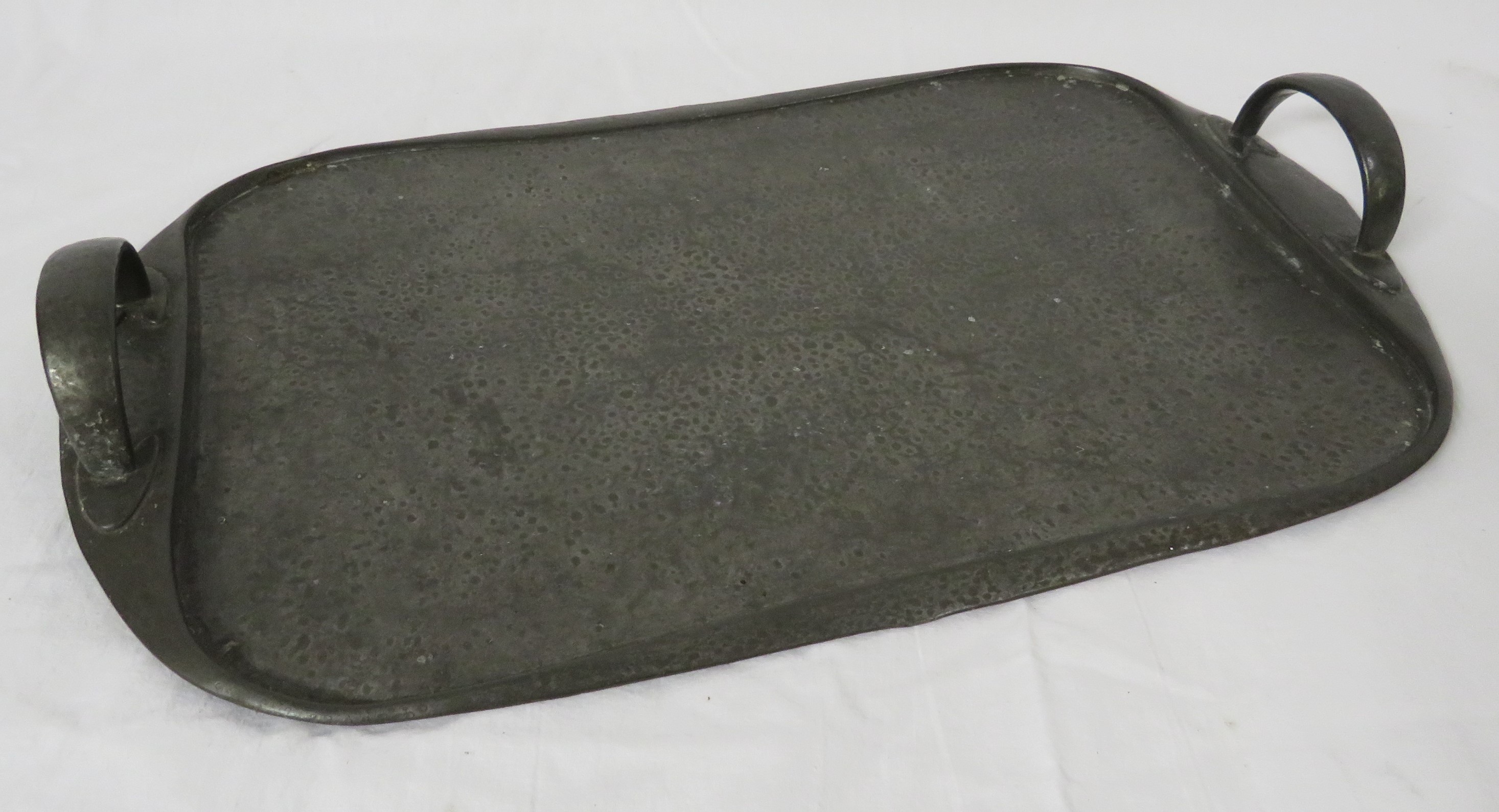 Arts and Crafts pewter serving tray, oblong with planished surface and two raised handles, 47.5cm
