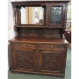 19th century rustic oak sideboard with extensive carving, the base with two drawers with green man