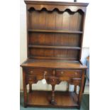Small oak reproduction dresser in 18th century style, the top with two plate racks, cornice and wavy