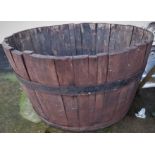 LARGE WOODEN AND METAL BANDED HALF BARREL PLANTER