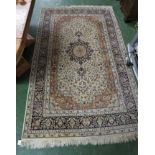 BEIGE GROUND FOLIATE PATTERNED FLOOR RUG WITH TASSELLED ENDS