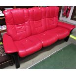 EKORNES STRESSLESS MANUALLY RECLINING THREE SEATER SOFA WITH BLACK COLOURED FRAME AND BRIGHT RED