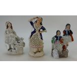 Three female Staffordshire figures - girl with rabbit, two girls and dancing girl. 16.5 - 19.