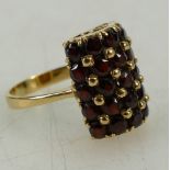 18ct gold unusual garnet set dress ring, size O weight 8.2g.