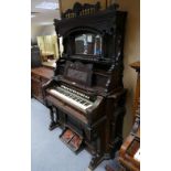 A walnut ornate pump organ with a mirrored back marked Story A Clark Chicago U.S.