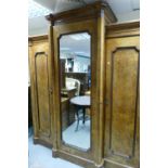 A large early Victorian burr wall three door break front gentleman's wardrobe with central mirrored