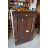 Early oak single door corner wall hanging cupboard with brass H hinges