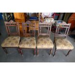 A set of four walnut Edwardian upholstered dining chairs