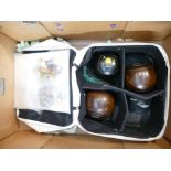 A collection of hard wood crown green bowls in carry case with similar medals and pin badges