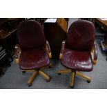 A pair of vintage burgundy leather swivel office arm chairs (2)