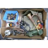 A collection of military items to include a bugle, gas mask, handcuffs,