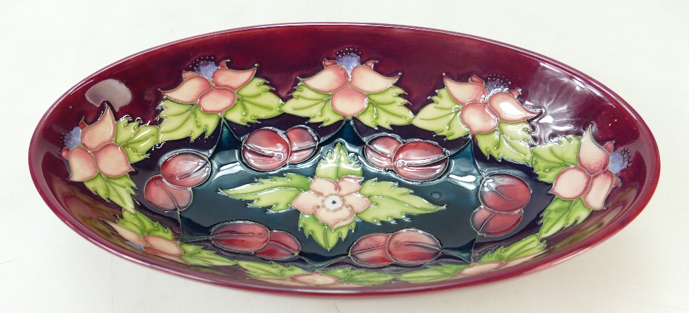 Moorcroft oval sided dish decorated in the cherries morello design,