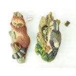 Two Bossons wall ornaments, Woodpecker and Racoon with tags.