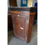 A large Georgian wall hanging corner cupboard with H brass hinges