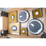 A collection of Wedgwood wall plates and framed items