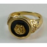 18ct gold & onyx set ring with Lions head decoration & diamond set shoulders. Size N. 4.7g.