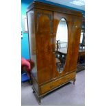 Edwardian burr walnut & walnut wardrobe, with a single oval mirrored door,