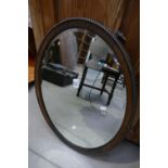 Early 20th Century oval bevel edged and beaded oak framed wall hanging mirror