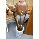 A ceramic floral umbrella stand with 3 walking sticks, including a knotted bamboo stick,