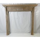 An early Georgian pitch pine Neo Classical fire surround.