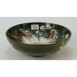Large Moorcroft fruit bowl decorated in the wildflower design on green ground,