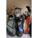 A large mixed selection of modern and vintage golfing equipment to include 4 Golf bags and clubs