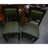 Pair of Edwardian oak dining chairs (one chair without casters)