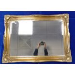Bevel edged gilt framed wall mirror.