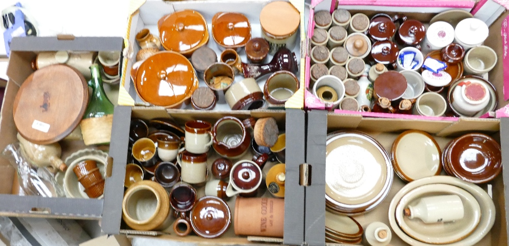 A large collection of brown glazed kitchen ware: Items including plates, storage jars, jugs,